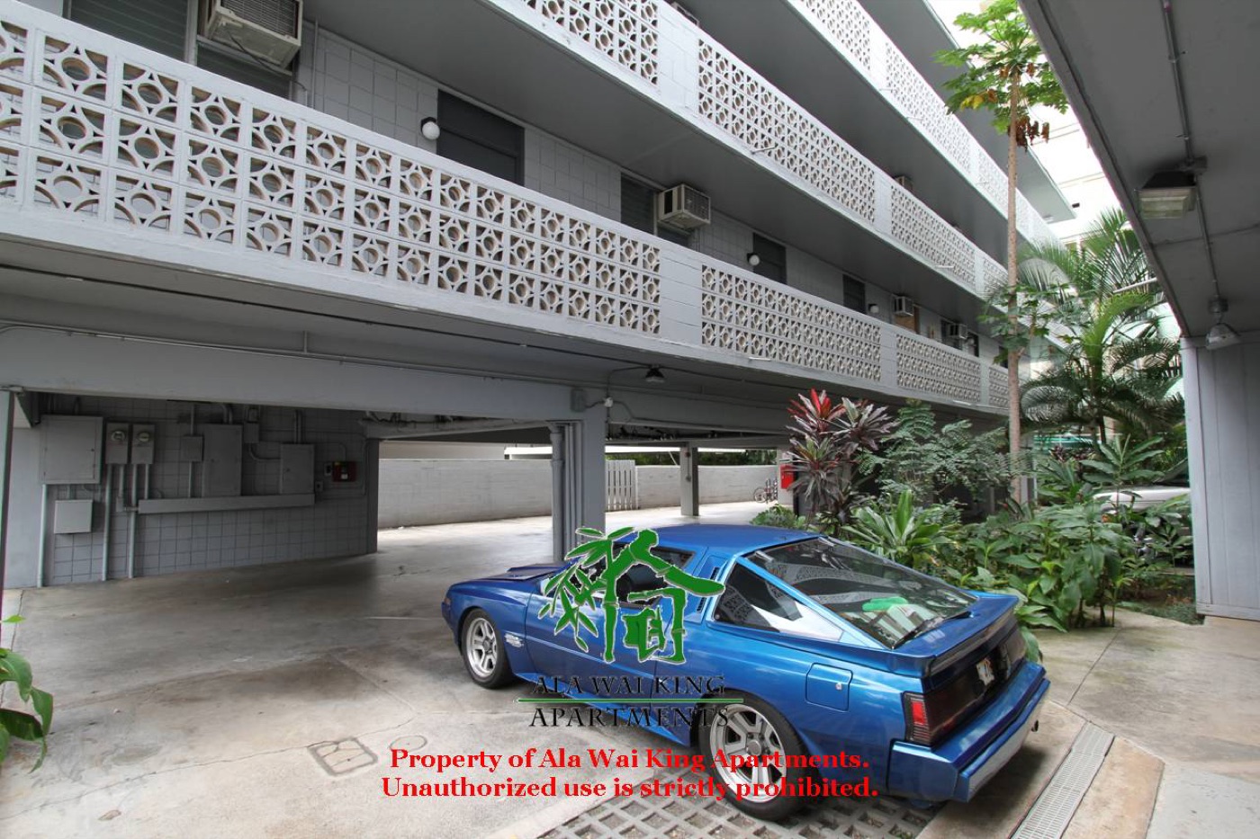 Covered parking area with tropical landscaping